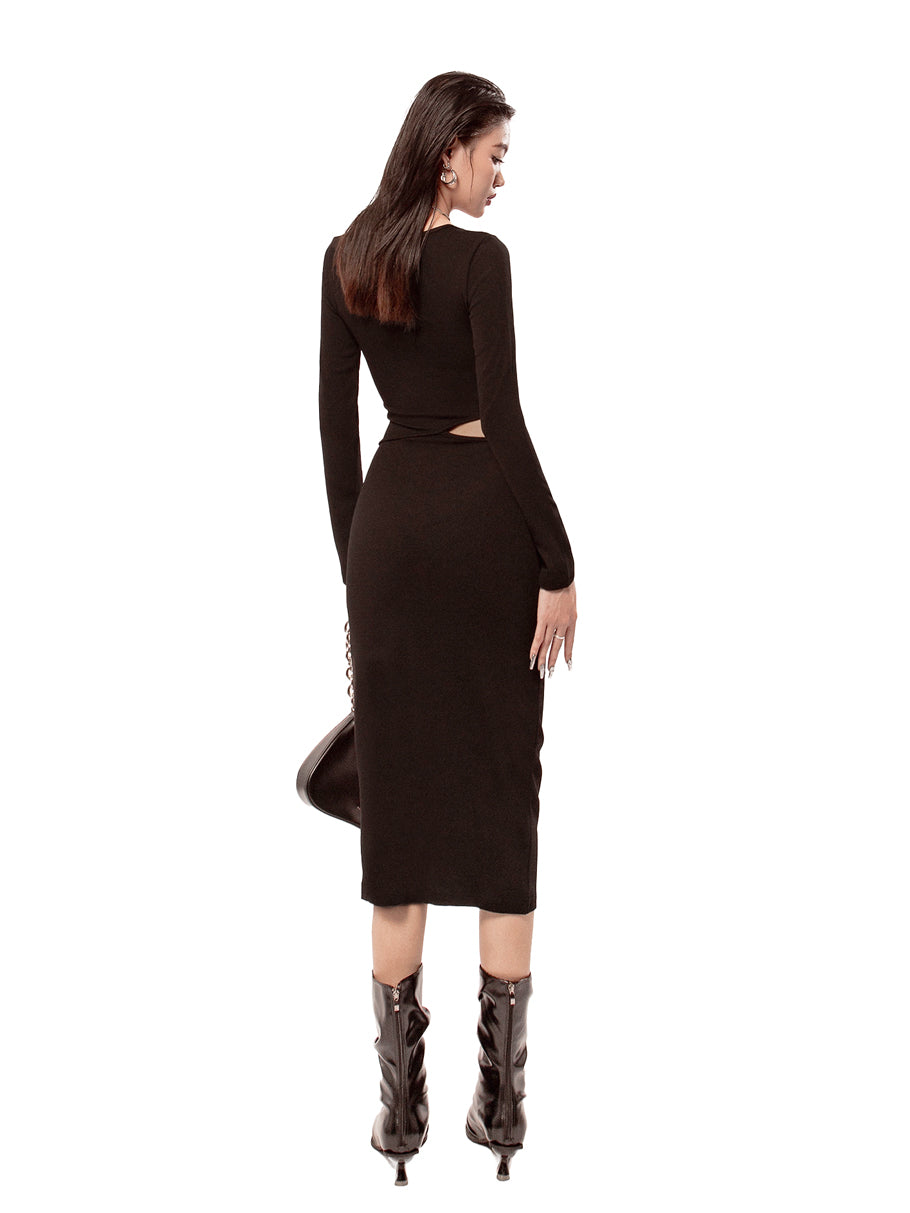 Woman wearing a black dress with cut-out design on a white background