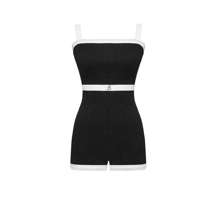 Black romper with white trim on a white background