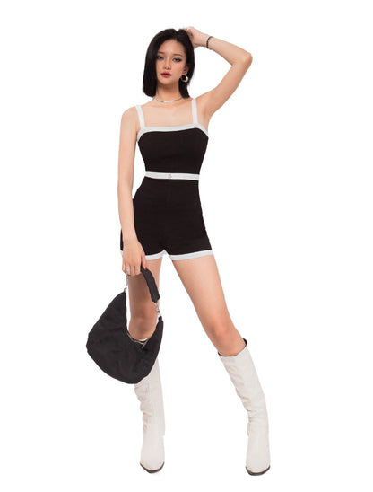 Woman wearing a black and white outfit with white boots on a white background