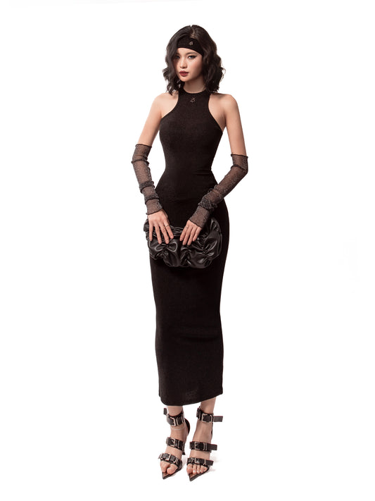 Woman wearing a black dress with long gloves and high heels on a white background
