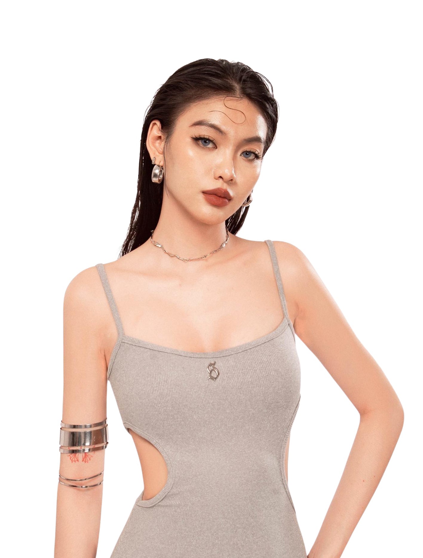 Woman wearing a gray tank top with cut-out design on a white background