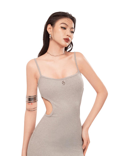 Woman wearing a gray dress with cut-out design on a white background