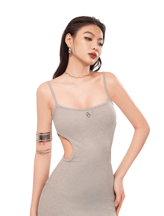Woman wearing a gray dress with cut-out design on a white background
