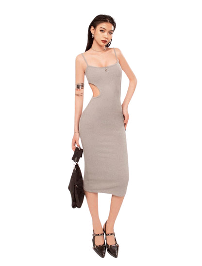 Woman wearing a gray dress with cut-out design on a white background