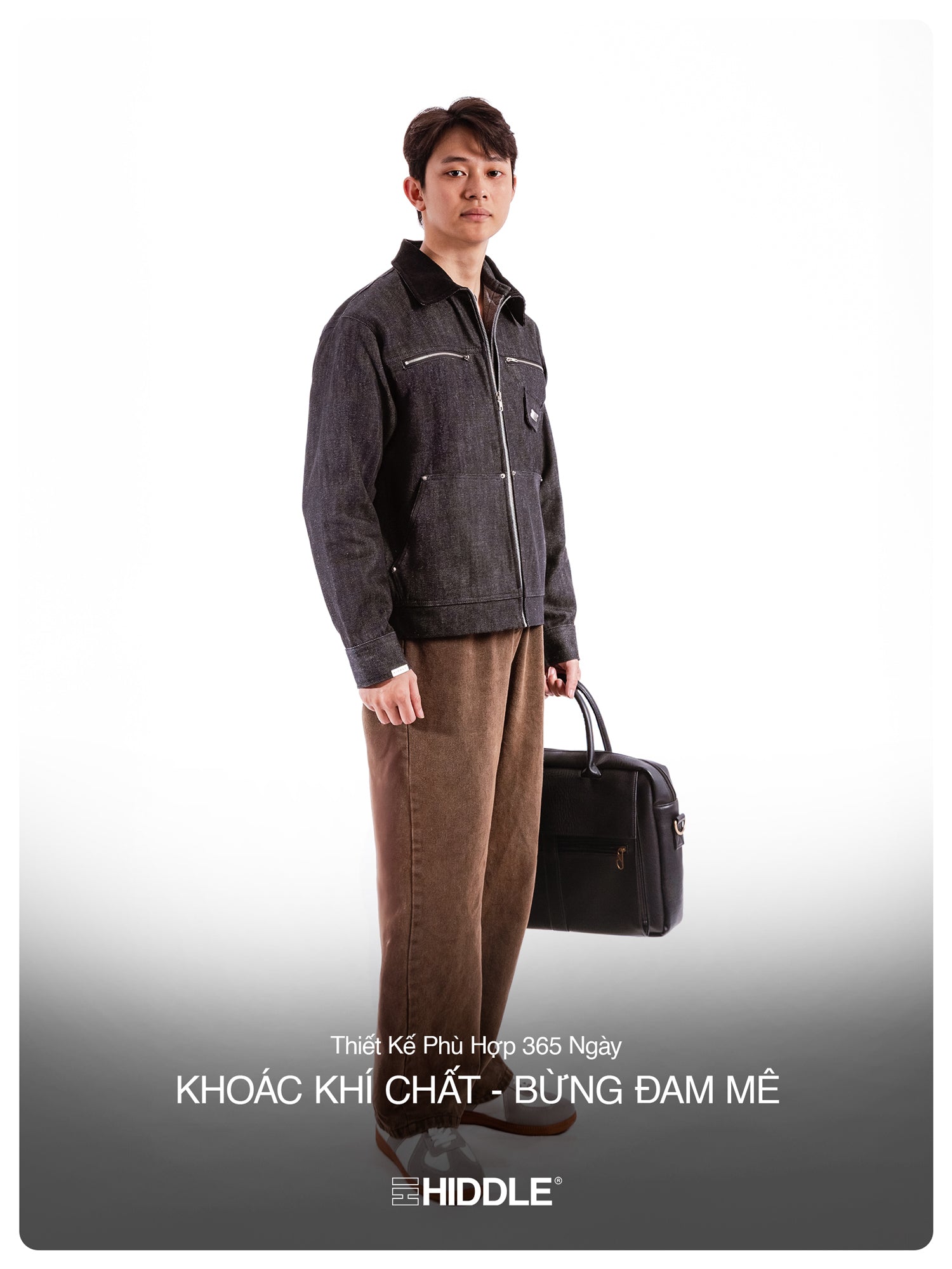 Man holding a briefcase wearing a dark jacket and brown pants on a white background with Hiddle branding.