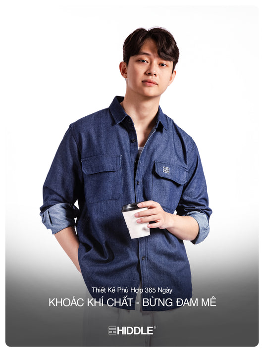 Man wearing a blue denim shirt holding a coffee cup on a white background with Hiddle branding.
