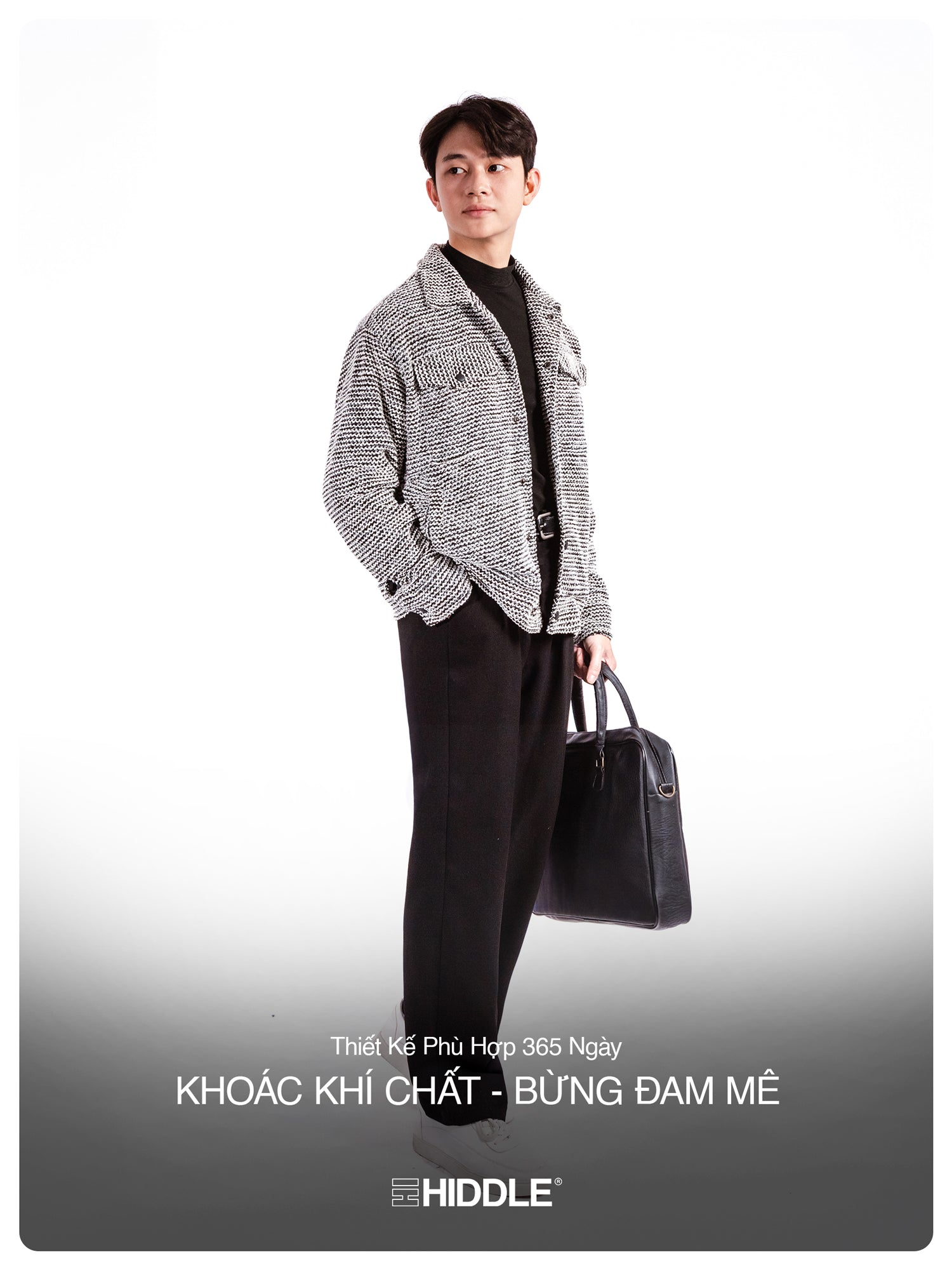 Man holding a black briefcase with 'Hiddle' branding on a gray background