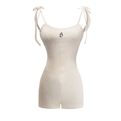 Beige ribbed bodysuit with thin straps on a white background