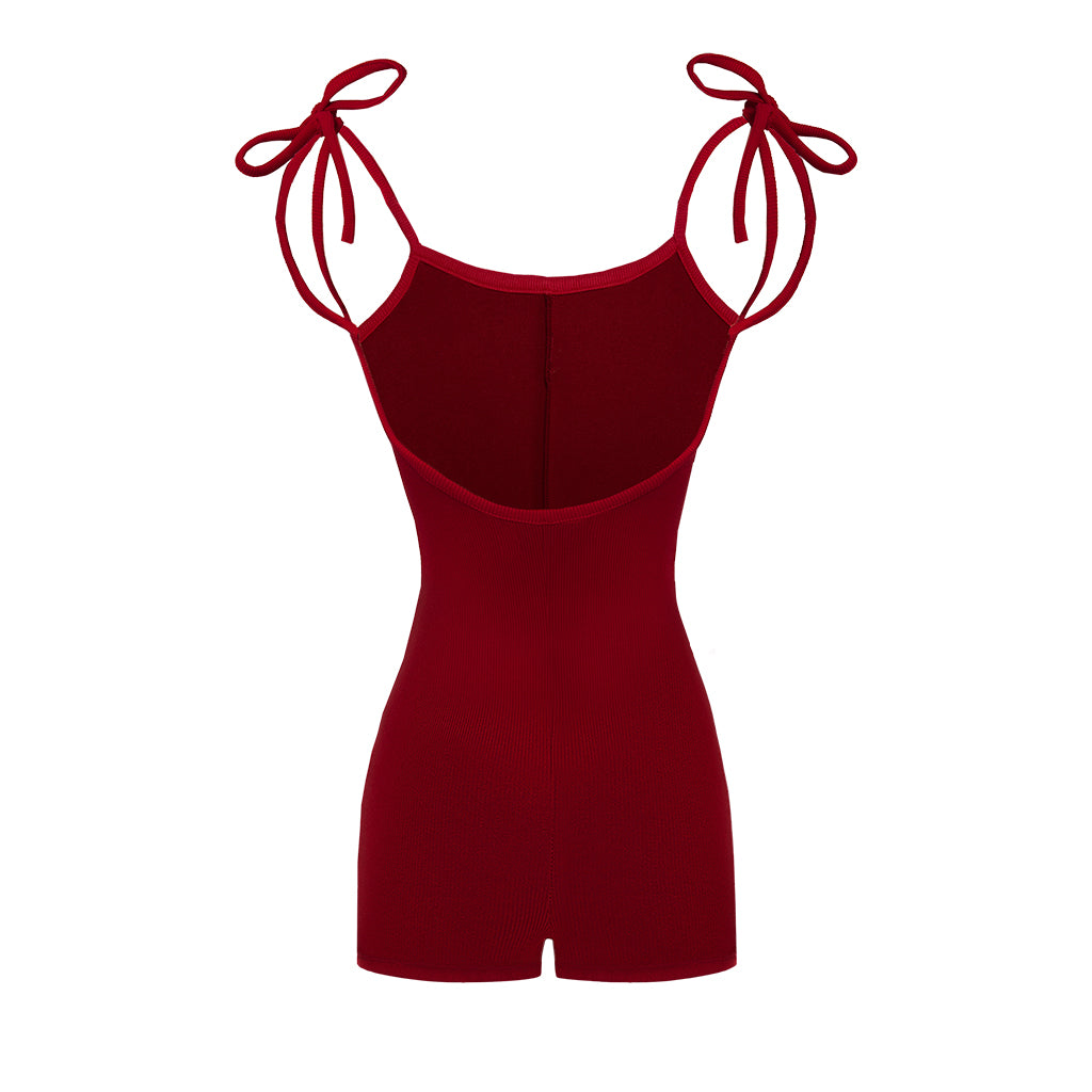 Red romper with bow straps on a white background