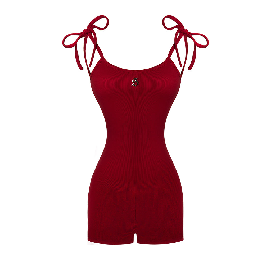 Red romper with tied sleeves on a white background
