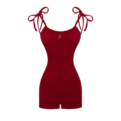Red romper with tied sleeves on a white background