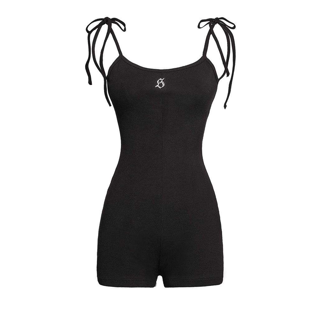 Black romper with tie straps on a white background