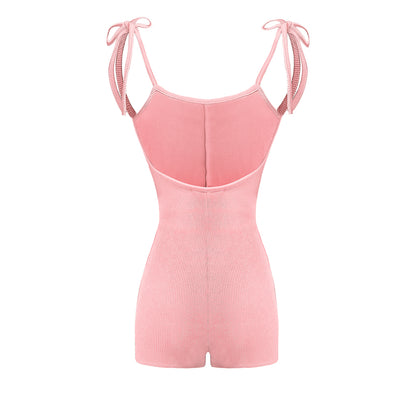 Pink romper with thin straps on a white background
