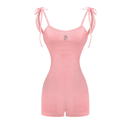 Pink romper with thin straps on a white background