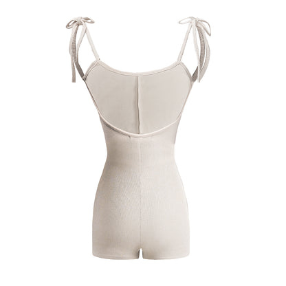 Beige ribbed romper with thin straps on a white background