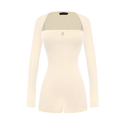 Beige long-sleeve top with a brand logo on a white background