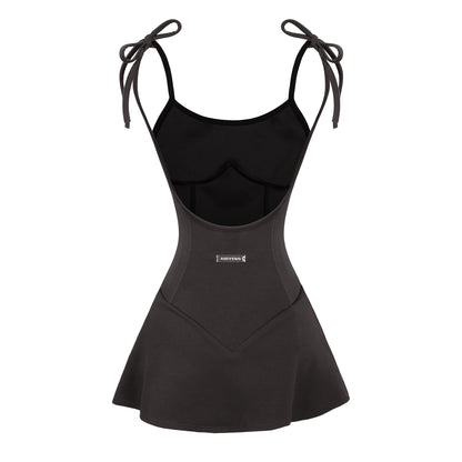 Black swimsuit with bow straps on a white background