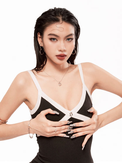 Woman wearing a black and white dress with a plunging neckline on a white background