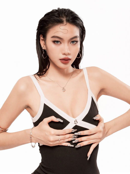 Woman wearing a black and white dress with a plunging neckline on a white background