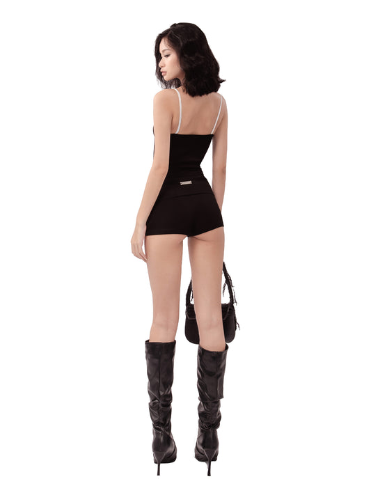 Woman wearing a black dress and high-heeled boots on a white background
