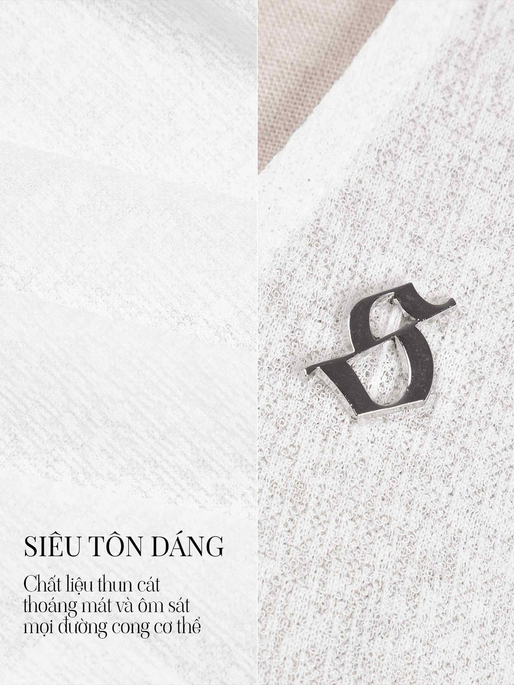 Black letter 'S' brooch on a textured white background
