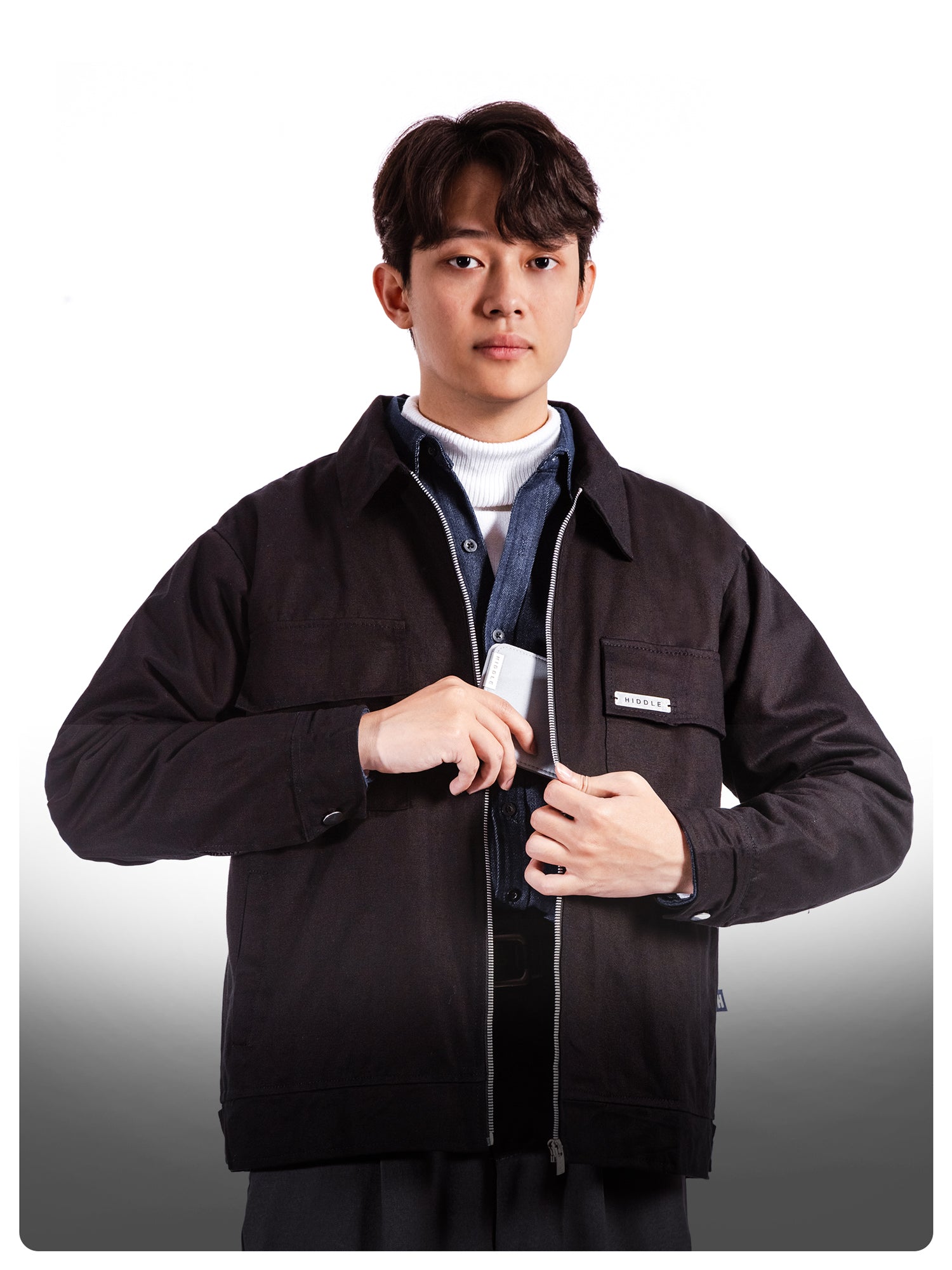 Person wearing a black jacket with a white background