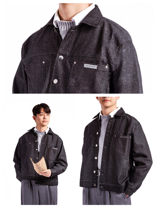 Dark denim jacket worn by a person on a white background