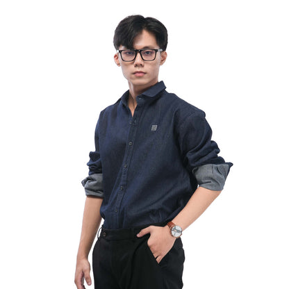 Man wearing a navy blue shirt with rolled-up sleeves on a white background