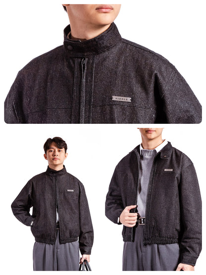 Dark gray jacket with brand logo worn by a person on a white background