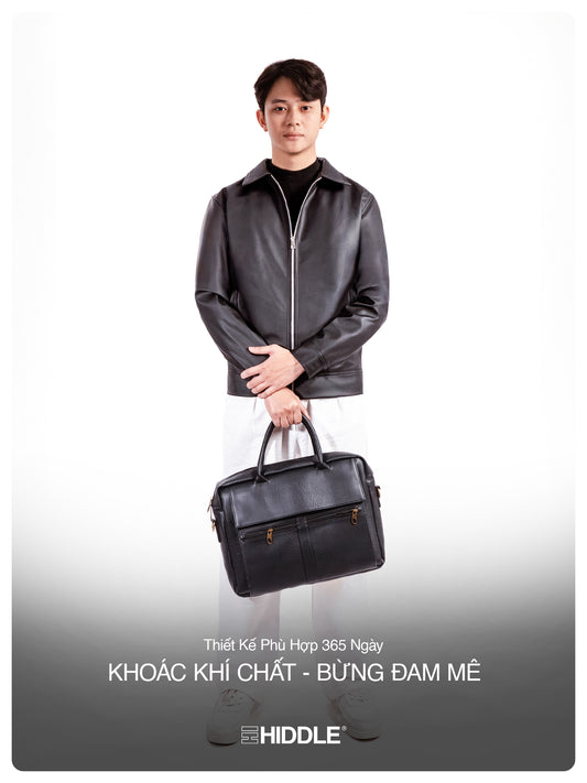 Man holding a black leather briefcase with a gray background and Hiddle branding.