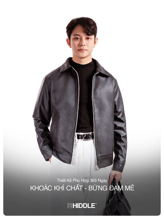 Man wearing a gray leather jacket with Hiddle branding on a white background
