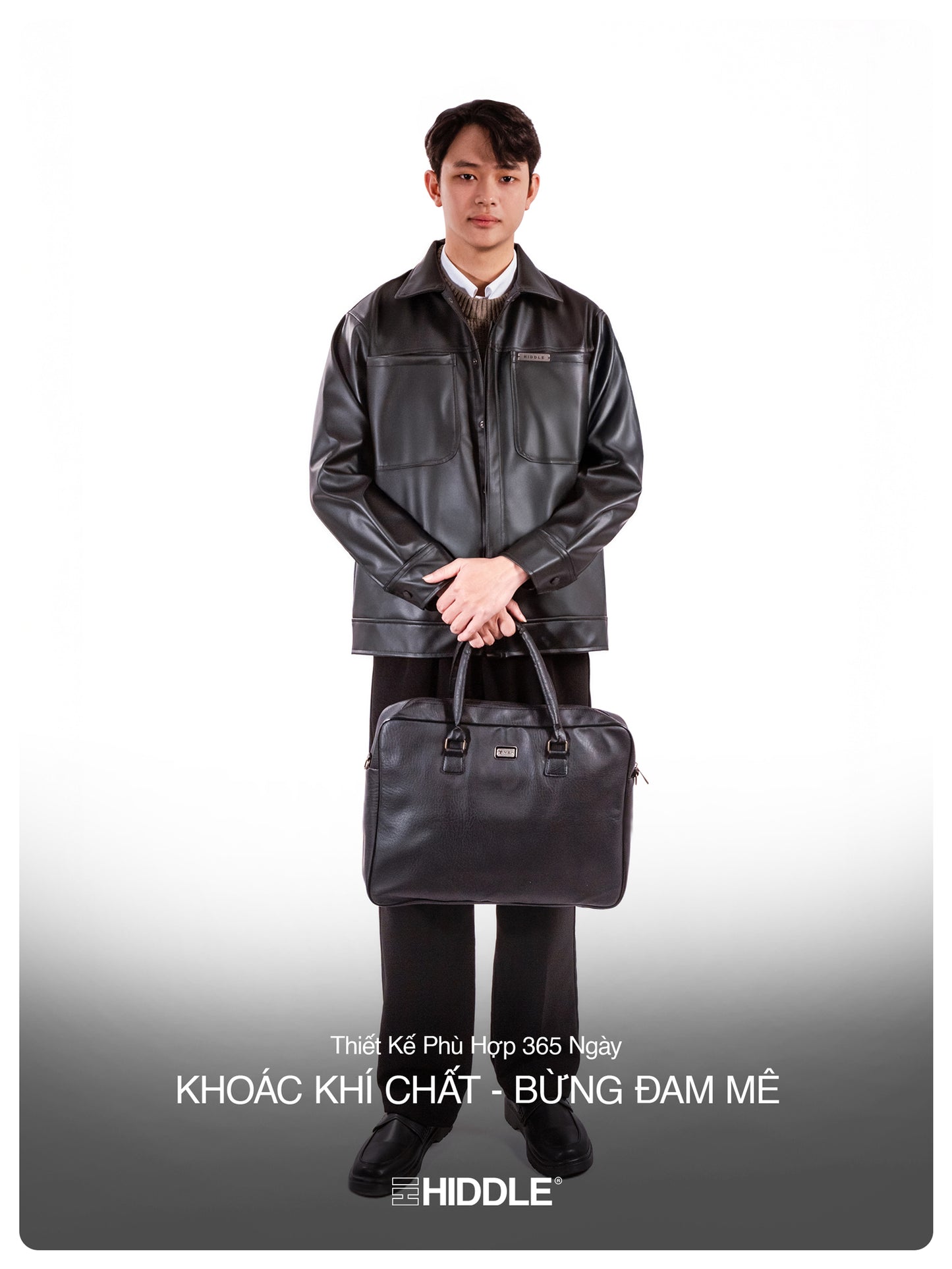 Man holding a black leather briefcase against a white background