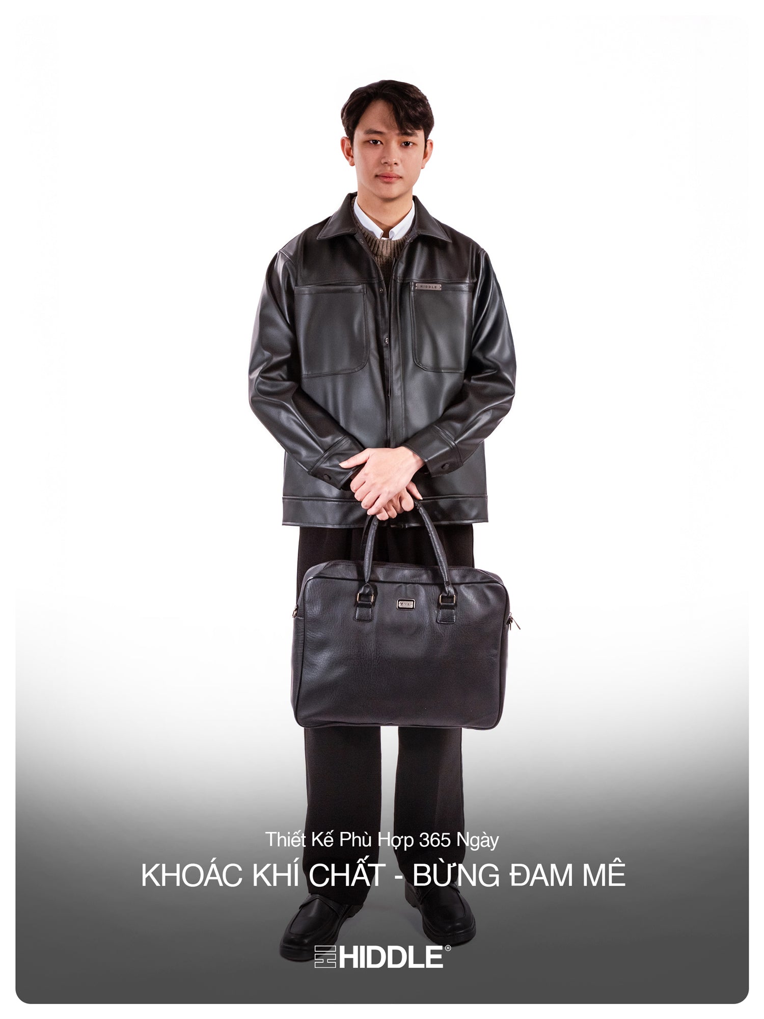 Man holding a black leather briefcase against a white background