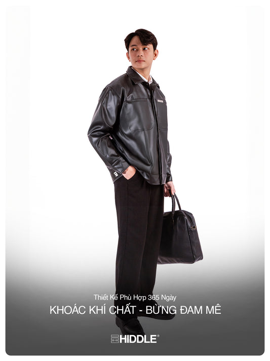 Man wearing a black leather jacket and holding a bag on a white background with Hiddle branding.