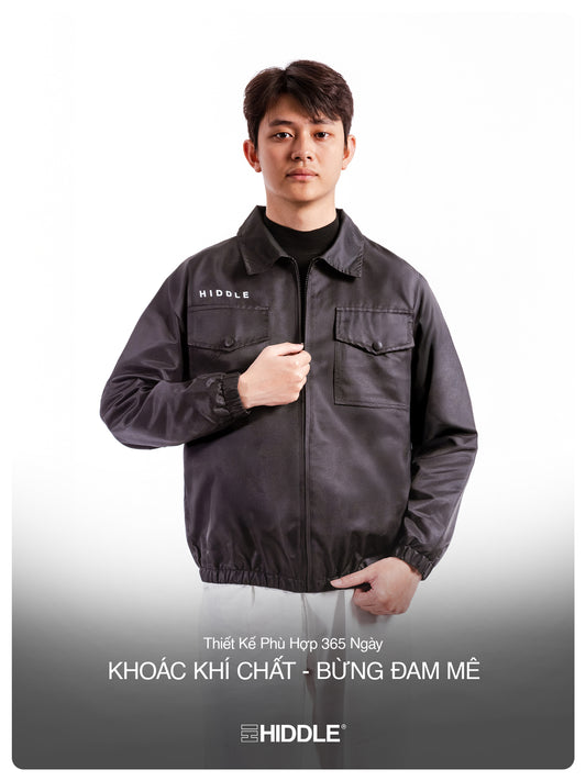 Person wearing a dark jacket with 'Hiddle' branding on a white background