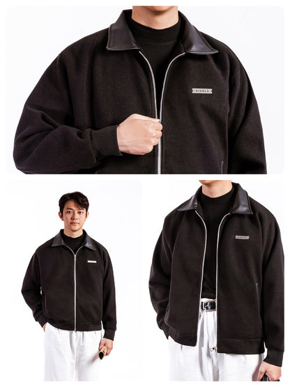 Black jacket with a brand logo worn by a person on a white background