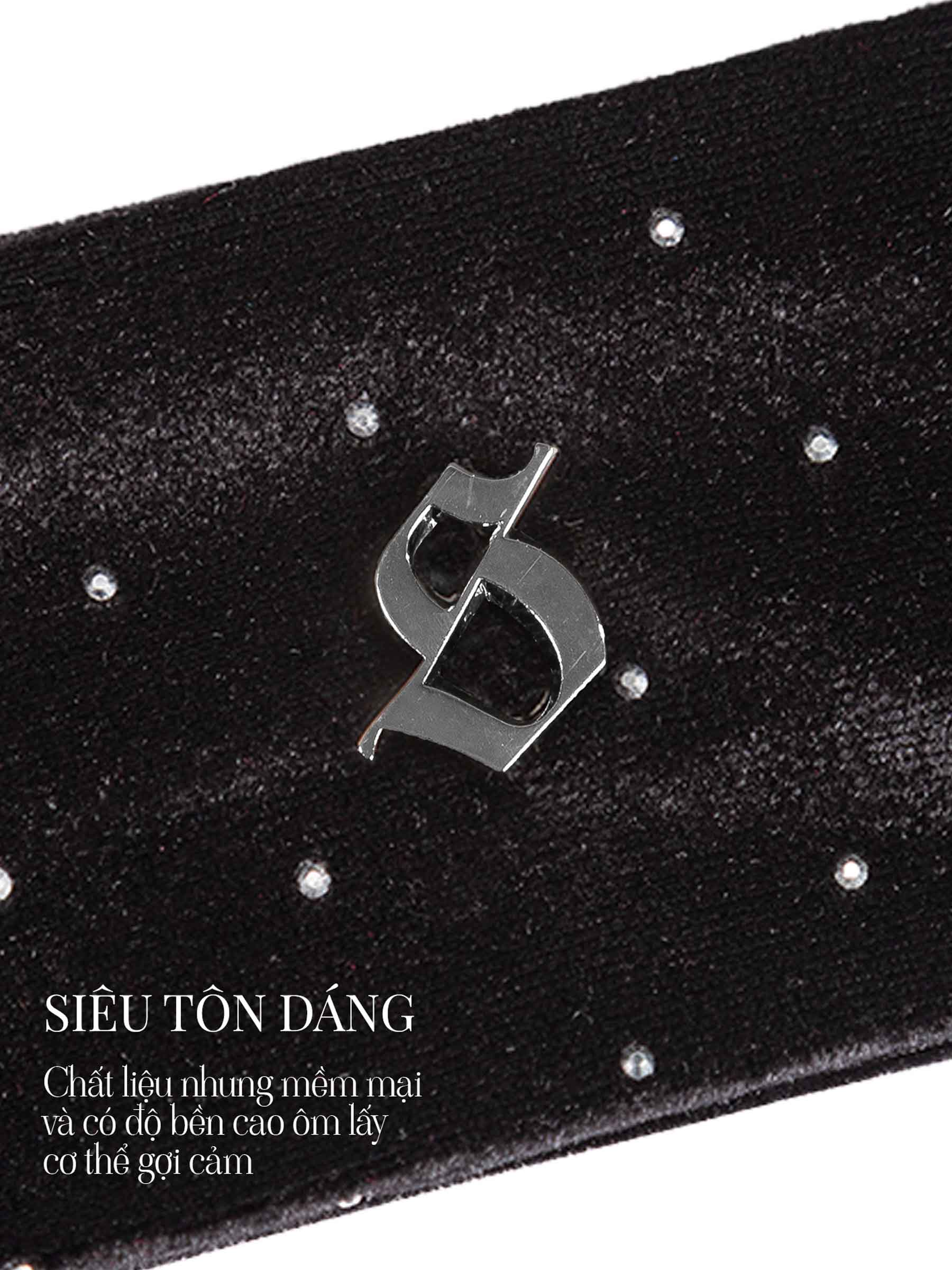 Black belt with a metallic logo and sparkling stones on a white background