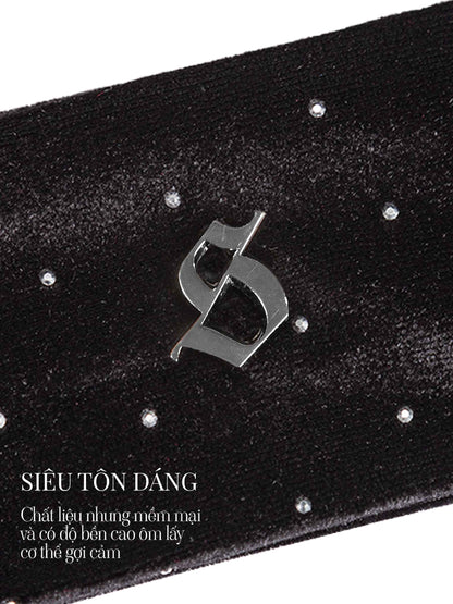 Black belt with a metallic logo and sparkling stones on a white background