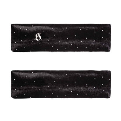 Two black satin headbands with white polka dots on a white background