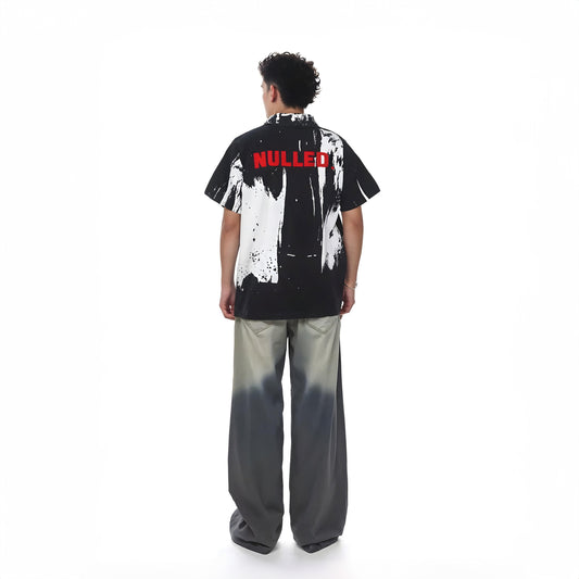 Person wearing a black and white patterned shirt with 'NULLED' text on a white background