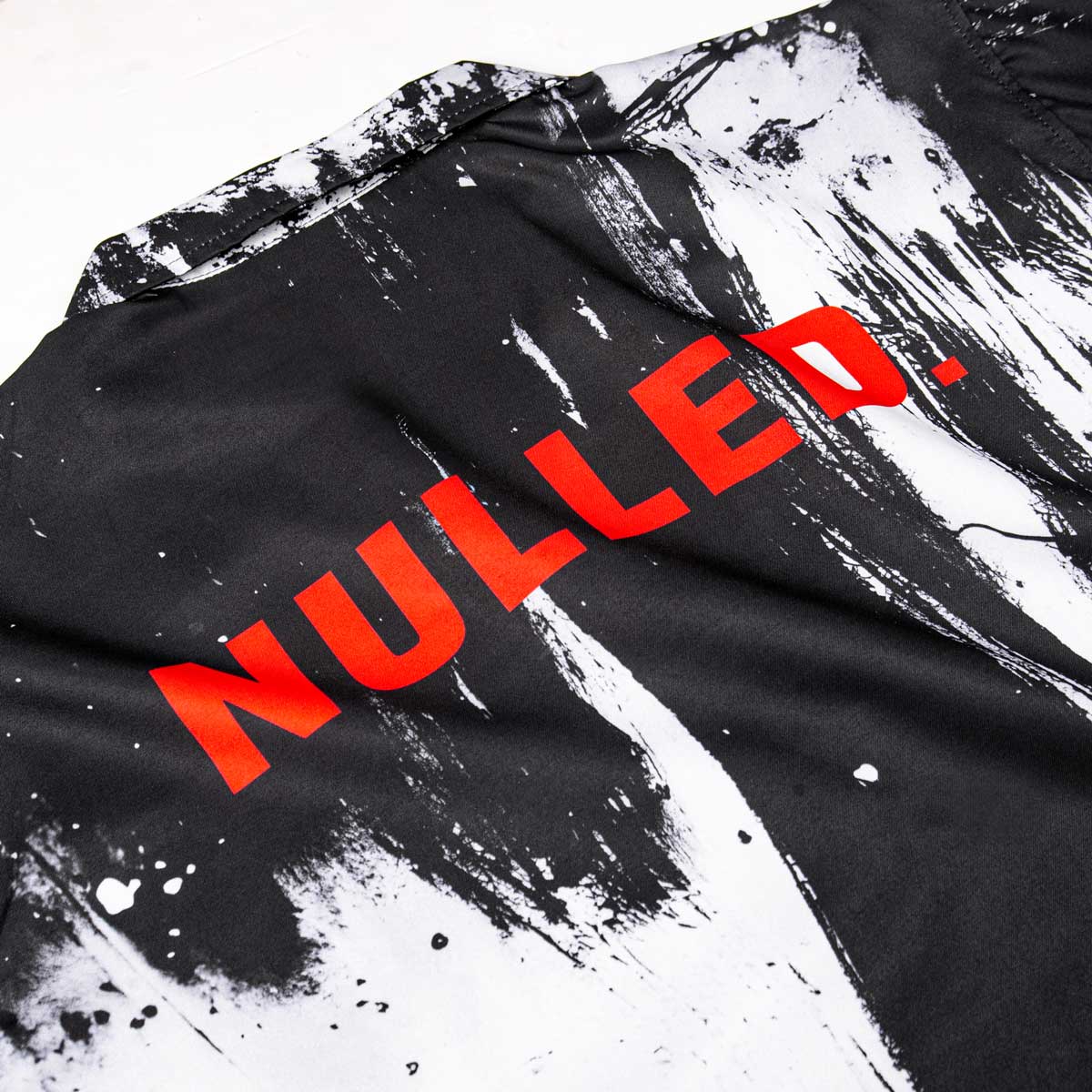 Black and white textured fabric with red 'NULLED' text