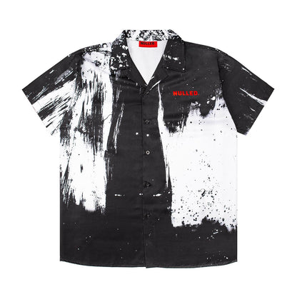 Black and white splatter pattern shirt with 'WULLED' branding on a white background