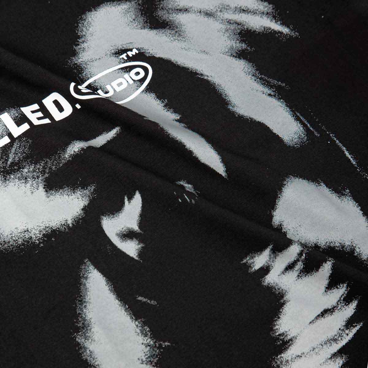 Black and white patterned fabric with a logo in the corner