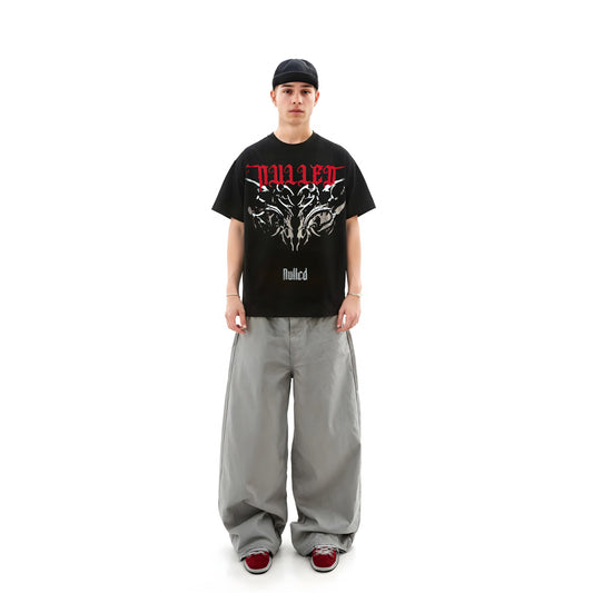 Person wearing a black t-shirt with red and white text and graphics on a white background