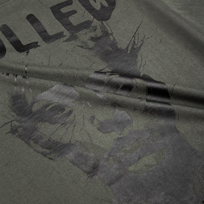 Close-up of a green fabric with text and floral patterns