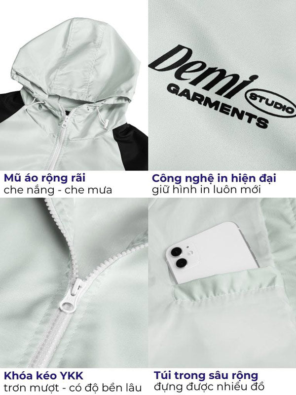 Light gray jacket with hood and zipper, featuring Demi Studio branding and product features.