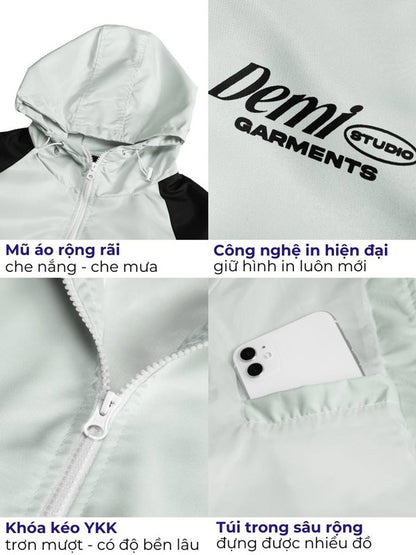 Light gray jacket with hood and zipper, featuring Demi Studio branding and product features.
