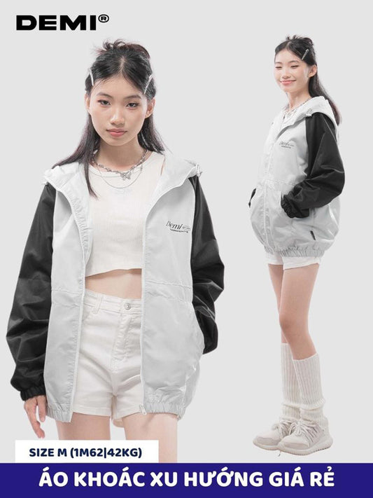 Two people wearing a black and white jacket with 'DEMI' branding on a white background.