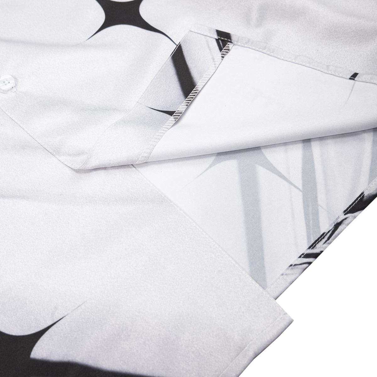 Close-up of a white shirt with black geometric patterns on a white background