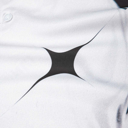 Close-up of a white shirt with a black geometric design on the chest.